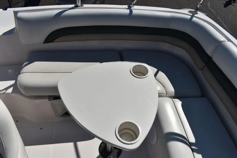 Slide: The Image of 2003 Hurricane SD 187 boat interior with cushioned seating and a triangular table. - 25