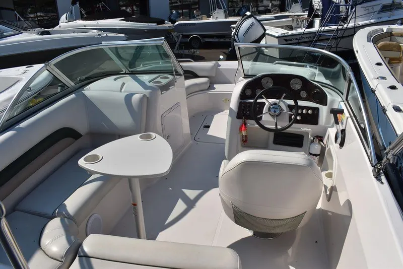 Slide: The Image of 2003 Hurricane SD 187 boat interior with steering console and seating area. - 26
