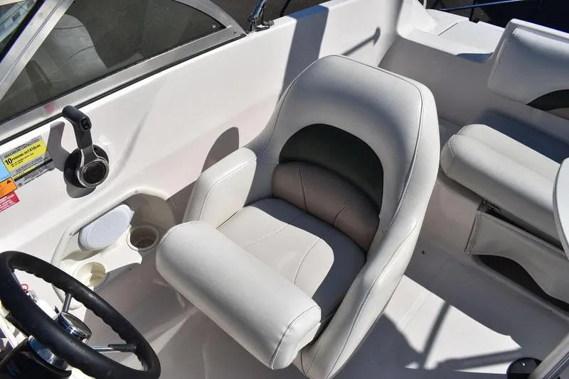 Slide: The Image of 2003 Hurricane SD 187 boat interior with white seating and steering wheel. - 28
