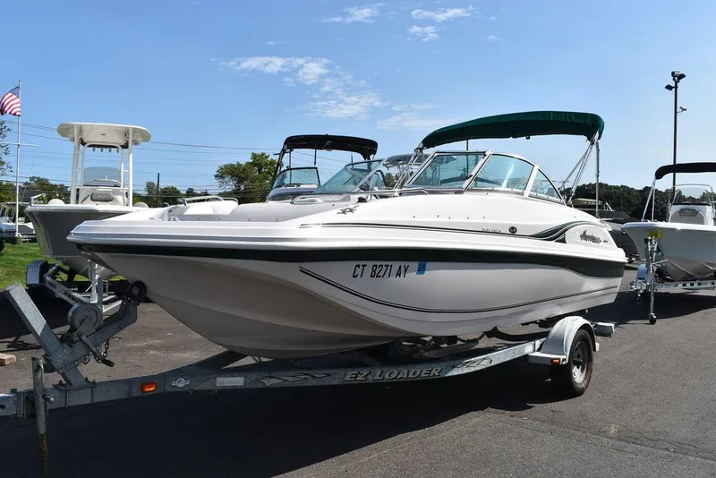 Slide: The Image of 2003 Hurricane SD 187 boat on trailer, parked outdoors under clear sky. - 3