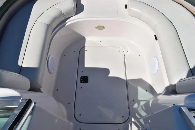 Slide: The Image of Interior view of a 2003 Hurricane SD 187 boat with white seating and storage. - 31