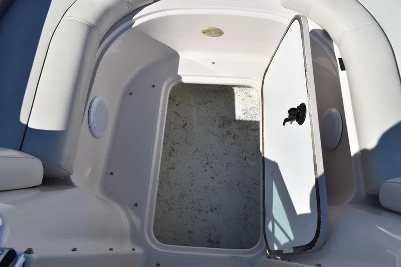 Slide: The Image of Open storage compartment on 2003 Hurricane SD 187 boat, featuring white interior and seating. - 32