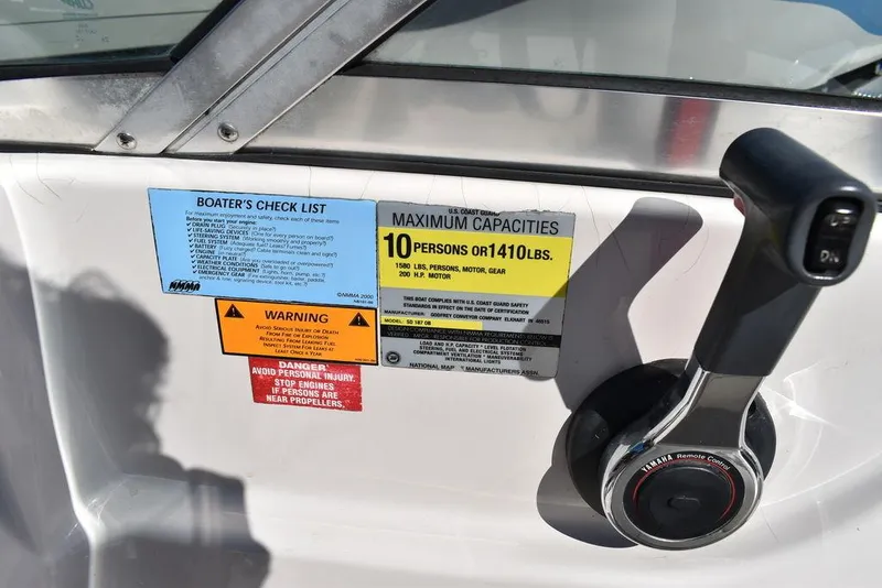 Slide: The Image of Control panel of a 2003 Hurricane SD 187 boat with capacity and safety labels. - 34