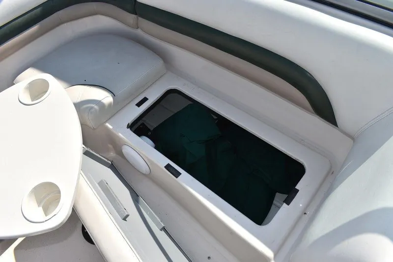 Slide: The Image of 2003 Hurricane SD 187 boat interior with open storage compartment and cup holders. - 39