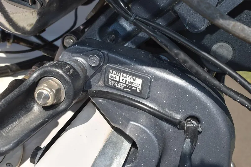Slide: The Image of Close-up of a Yamaha engine part on a 2003 Hurricane SD 187 boat. - 45