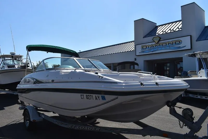 Slide: The Image of 2003 Hurricane SD 187 boat on trailer outside dealership. - 6