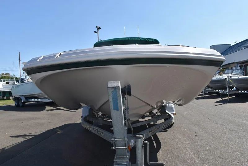Slide: The Image of 2003 Hurricane SD 187 boat on trailer, viewed from the front in a sunny outdoor setting. - 7
