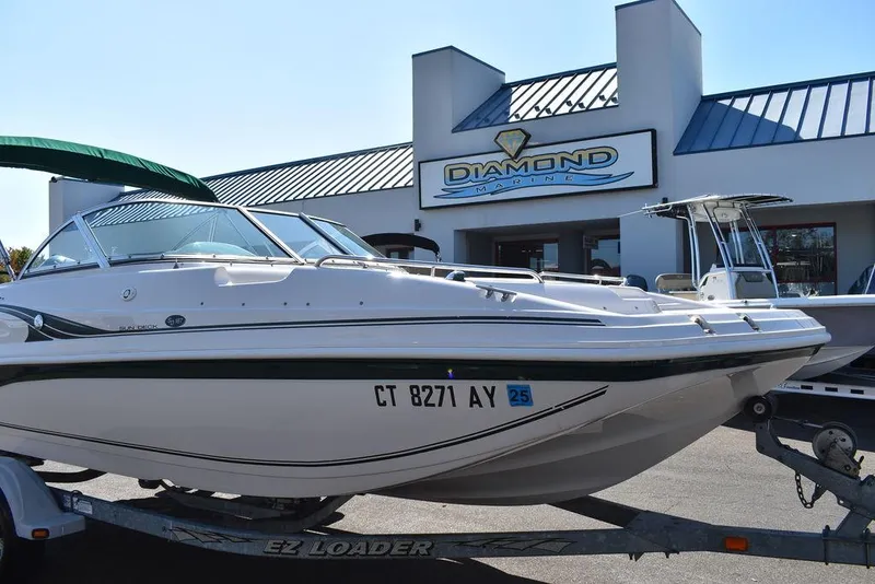 Slide: The Image of 2003 Hurricane SD 187 boat on trailer outside dealership, showcasing sleek design and registration number. - 9