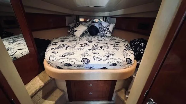 Slide: The Image of Interior cabin of 2005 Sea Ray 39 Sundancer with nautical-themed bedding. - 10