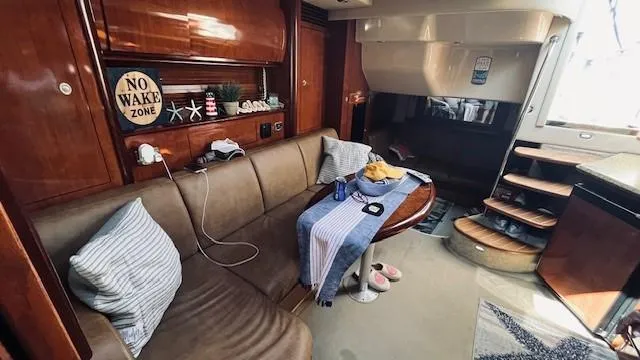 Slide: The Image of Interior of 2005 Sea Ray 39 Sundancer yacht with cozy seating and nautical decor. - 11