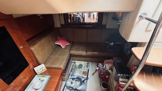 Slide: The Image of Interior of 2005 Sea Ray 39 Sundancer with cozy seating and nautical decor. - 12