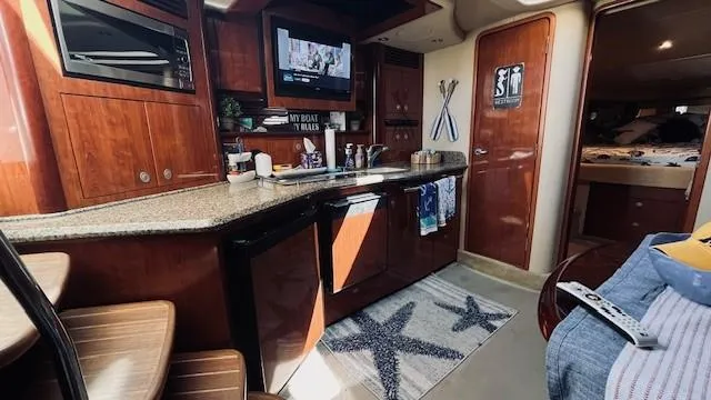 Slide: The Image of Luxurious 2005 Sea Ray 39 Sundancer yacht interior with modern kitchen amenities. - 13