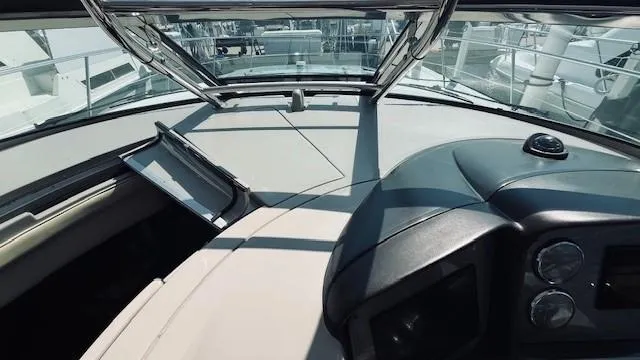 Slide: The Image of 2005 Sea Ray 39 Sundancer helm with modern controls and panoramic view. - 7