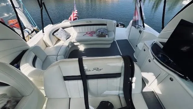 Slide: The Image of 2005 Sea Ray 39 Sundancer yacht interior with white seating and water view. - 8
