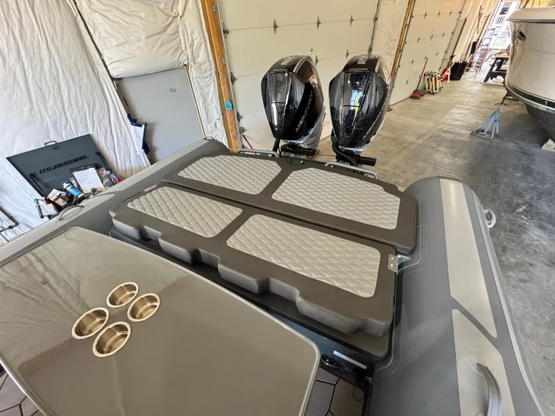 Slide: The Image of 2024 Highfield Sport 900 boat with dual engines in a garage setting. - 13