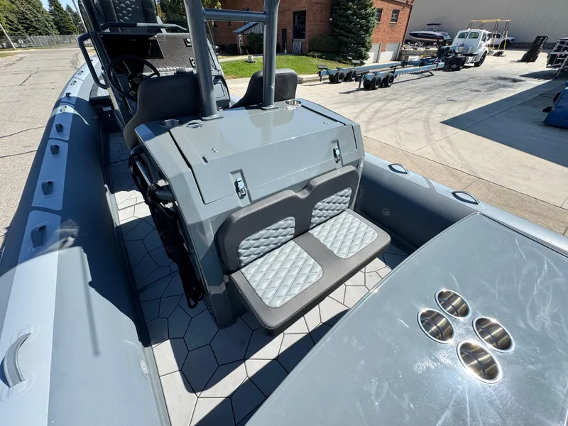 Slide: The Image of 2024 Highfield Sport 900 boat interior with gray seating and hexagonal flooring. - 17