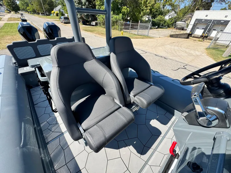 Slide: The Image of 2024 Highfield Sport 900 boat interior with dual seats and steering wheel. - 28