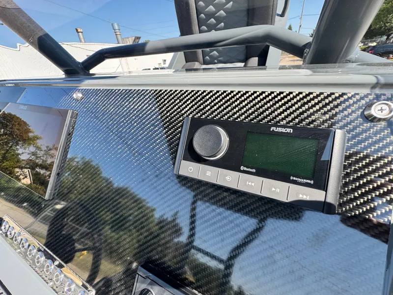 Slide: The Image of Carbon fiber dashboard of 2024 Highfield Sport 900 with Fusion audio system. - 31