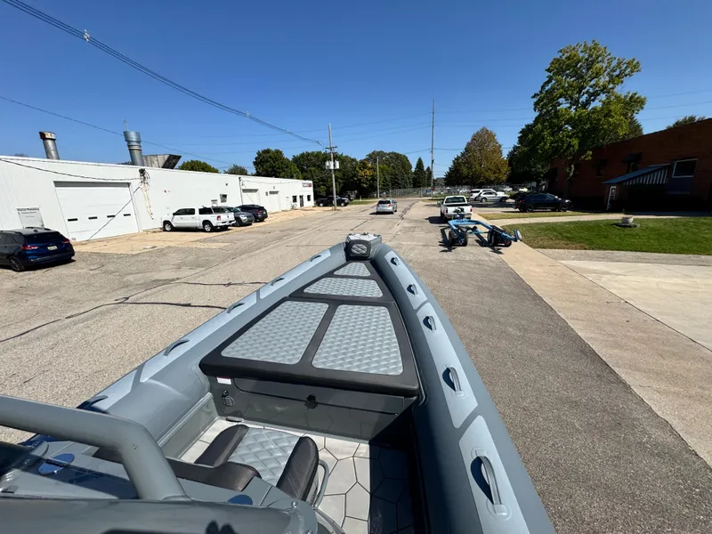 Slide: The Image of 2024 Highfield Sport 900 boat on a street, showcasing sleek design and spacious deck. - 39
