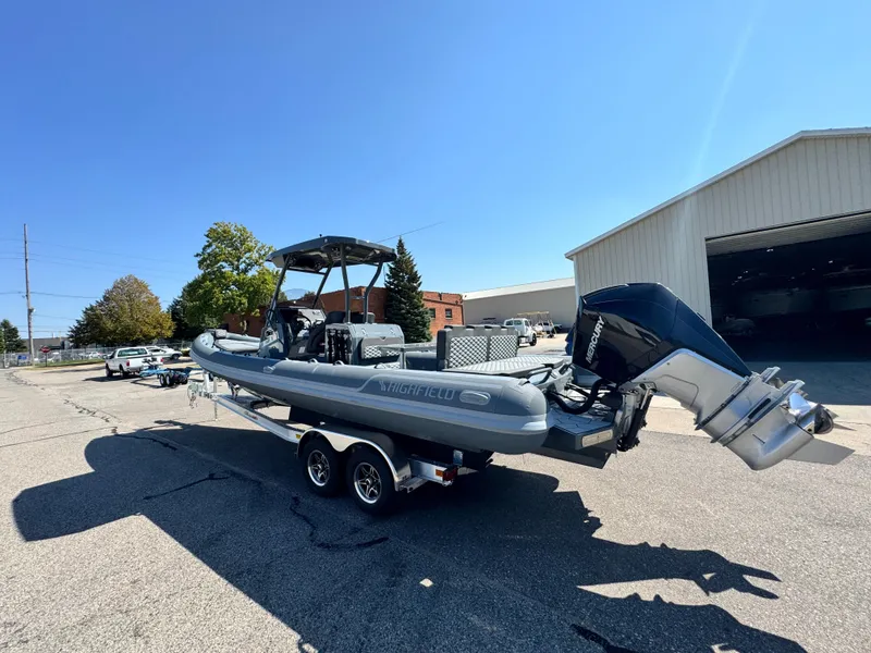 Slide: The Image of 2024 Highfield Sport 900 boat on trailer, parked outdoors under clear sky. - 41