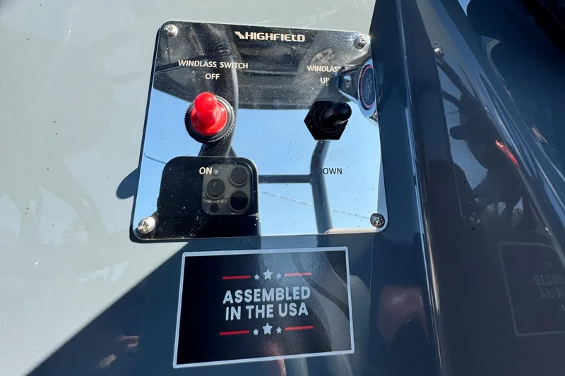 Slide: The Image of Control panel of 2024 Highfield Sport 900 boat, featuring windlass switch and "Assembled in the USA" label. - 43