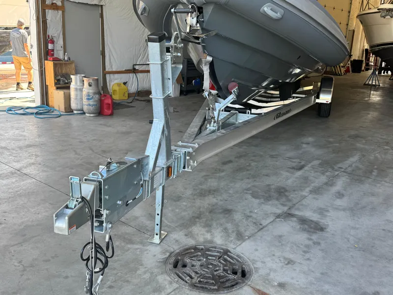Slide: The Image of 2024 Highfield Sport 900 boat on trailer in storage facility. - 5