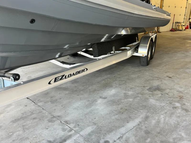 Slide: The Image of 2024 Highfield Sport 900 boat on EZ Loader trailer in garage. - 6