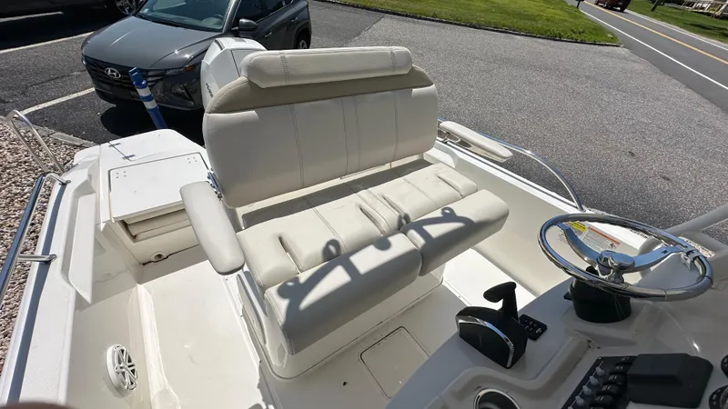 Slide: The Image of 2025 Boston Whaler 220 Dauntless boat interior with steering wheel and seating. - 10
