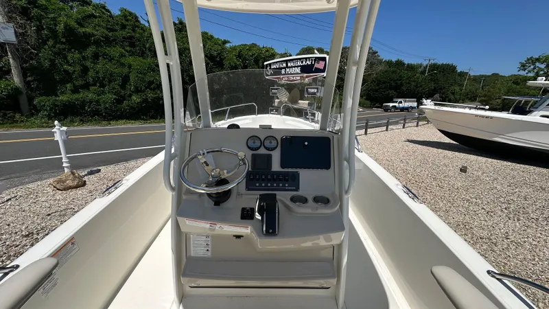 Slide: The Image of 2025 Boston Whaler 220 Dauntless boat dashboard with steering wheel and controls. - 11