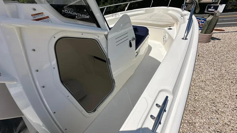 Slide: The Image of 2025 Boston Whaler 220 Dauntless boat interior with open storage compartment. - 13