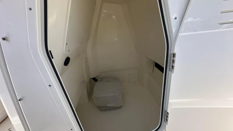 Slide: The Image of Interior cabin of 2025 Boston Whaler 220 Dauntless boat, featuring white finish. - 14