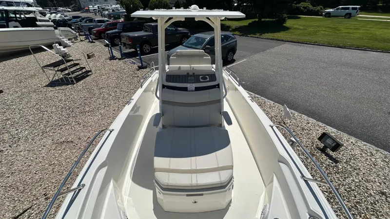 Slide: The Image of 2025 Boston Whaler 220 Dauntless boat on display in a marina setting. - 17