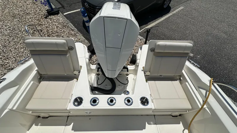 Slide: The Image of 2025 Boston Whaler 220 Dauntless boat interior with seating and engine view. - 5