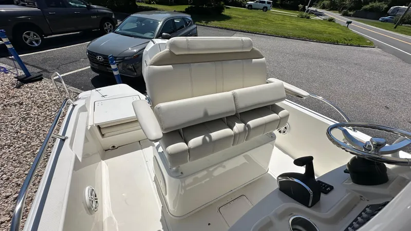 Slide: The Image of 2025 Boston Whaler 220 Dauntless boat interior with steering wheel and seating. - 9