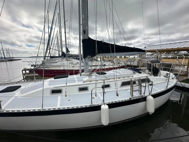 Slide: The Image of 1979 Valiant 37 sailboat docked at marina under cloudy sky. - 1