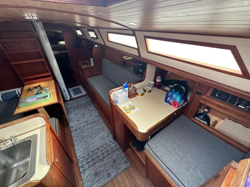 Slide: The Image of 1979 Valiant 37 sailboat interior with wood finish and seating area. - 12