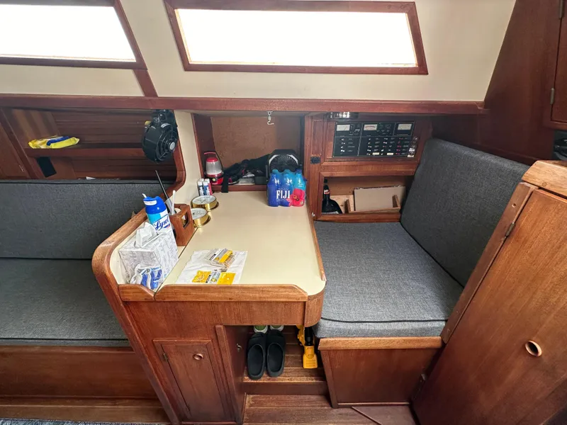 Slide: The Image of 1979 Valiant 37 sailboat interior with seating, table, and storage. - 19
