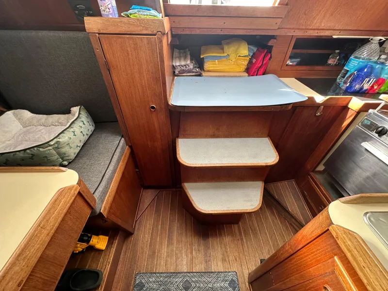 Slide: The Image of Interior of 1979 Valiant 37 sailboat with wooden steps and storage. - 22