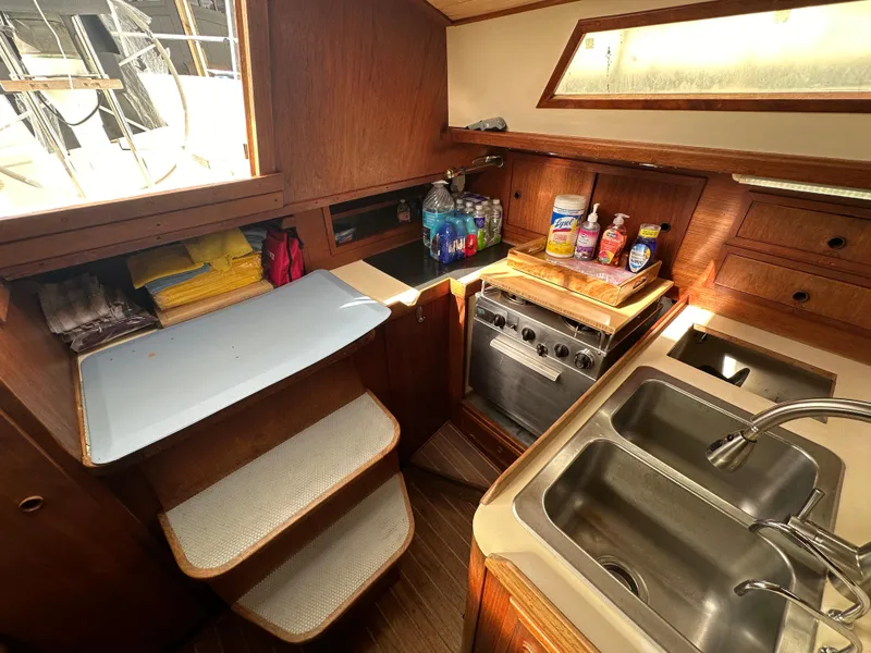 Slide: The Image of 1979 Valiant 37 yacht kitchen with stove, sink, and storage. - 23