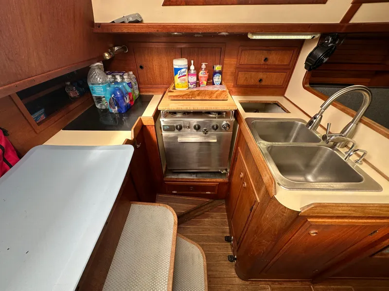 Slide: The Image of 1979 Valiant 37 yacht kitchen with stove, dual sinks, and wooden cabinetry. - 25