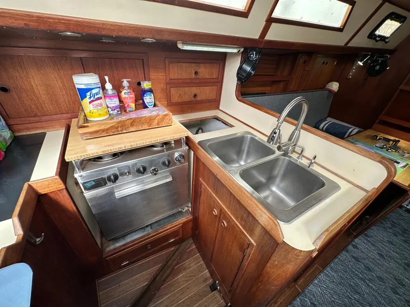 Slide: The Image of 1979 Valiant 37 yacht kitchen with dual sinks and stove. - 26