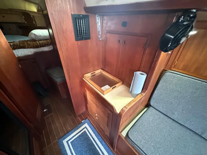 Slide: The Image of 1979 Valiant 37 yacht interior with wooden cabinetry and seating area. - 27