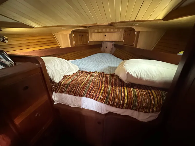 Slide: The Image of Cozy cabin interior of 1979 Valiant 37 sailboat with wooden paneling and bed. - 30