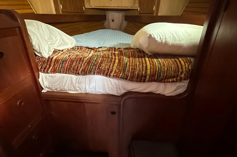 Slide: The Image of Cozy cabin bed in a 1979 Valiant 37 sailboat with wooden interior. - 31