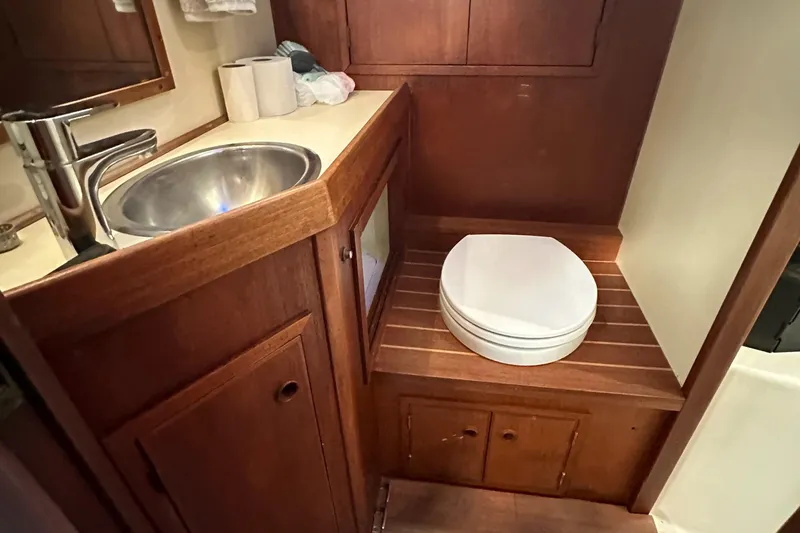 Slide: The Image of 1979 Valiant 37 yacht bathroom with wooden cabinetry and stainless steel sink. - 37