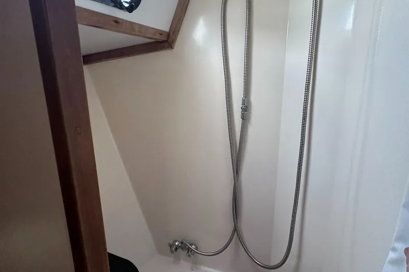 Slide: The Image of 1979 Valiant 37 boat shower with flexible hose and wooden trim. - 39