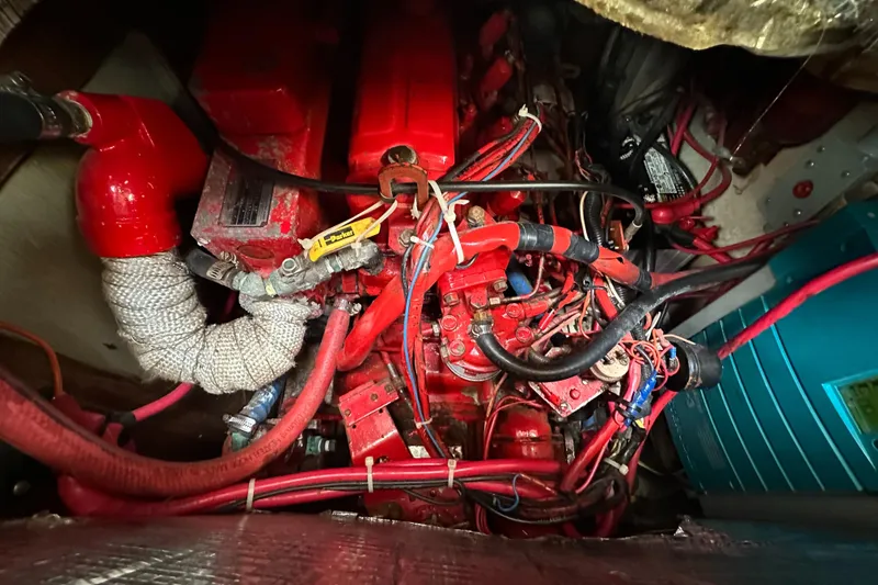 Slide: The Image of Engine compartment of a 1979 Valiant 37 sailboat, featuring red components and wiring. - 40