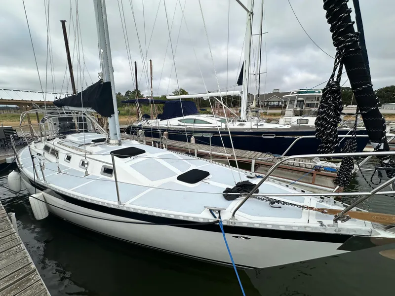 Slide: The Image of 1979 Valiant 37 sailboat docked in marina, overcast sky. - 5