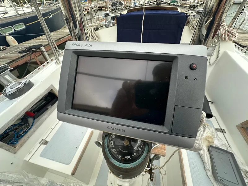 Slide: The Image of Garmin GPS on 1979 Valiant 37 sailboat cockpit, marina background. - 7