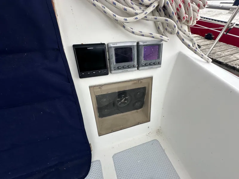 Slide: The Image of 1979 Valiant 37 sailboat cockpit with navigation instruments and coiled ropes. - 8